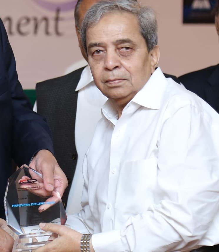 Engr. Nazar Siddiqui holding an inscribed glass shield bearing the logo of the Association of Consulting Engineers, Pakistan, with two other men beside him