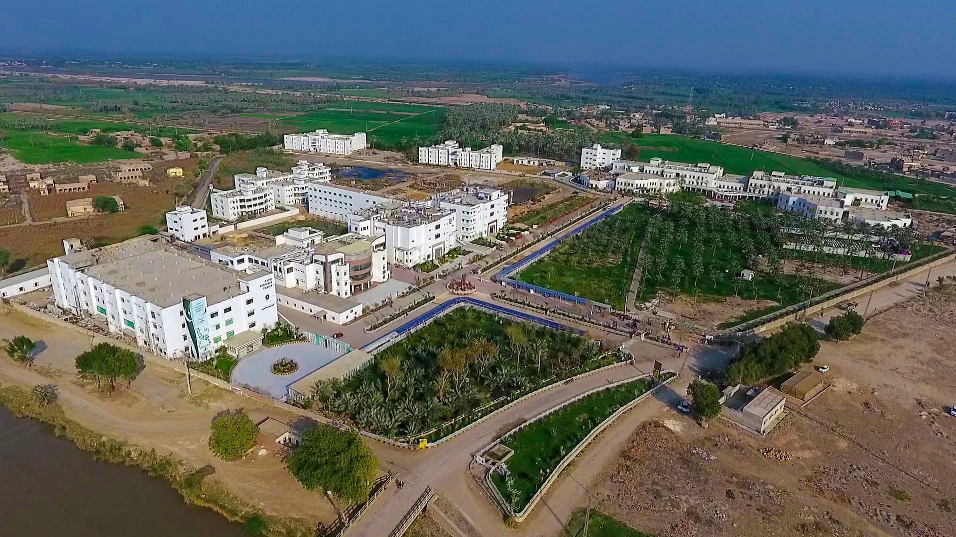 The institute from the air, with the Indus canal along its eastern edge Pir Abdul Qadir Shah Jeelani Institute of Medical Sciences (PAQSJIMS), Gambat, Khairpur, Sindh