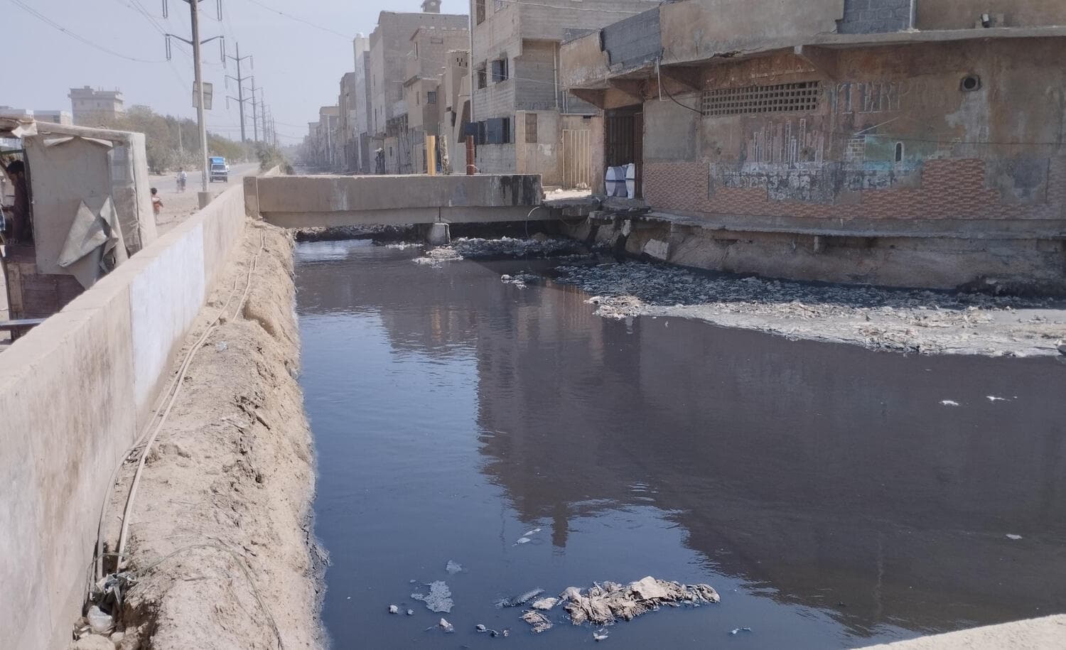 Existing condition — the nala alongside Road 10000, its retaining wall needing reconstruction. Road 10000 Rehabilitation, Korangi, Korangi, Karachi